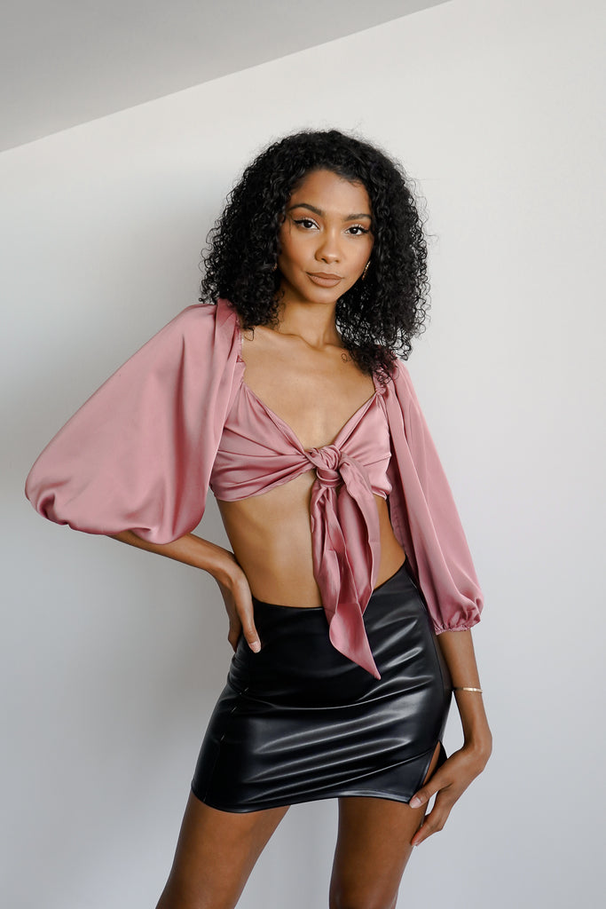 A satin crop top featuring a self-tie front, V-neckline, and long sleeves.
