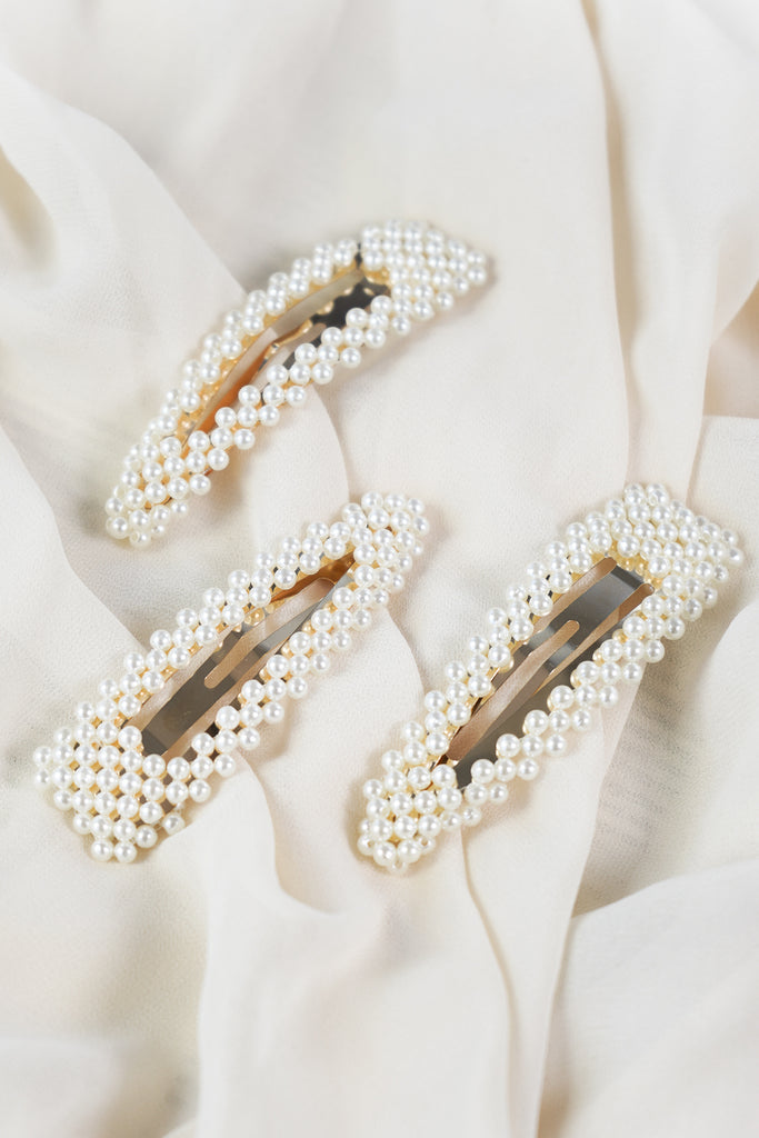 Accessorize your T-shirt and jeans combo with the Pearl Barrette. This thick hair clip can accommodate large pieces of hair, whether you need to keep it out of your face or you just want to try a new style. Small pearls dot its surface to add shimmer, shine and dimension to your look. 