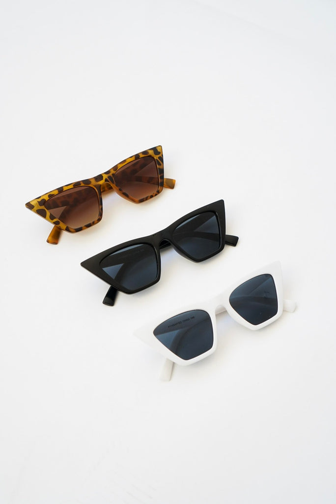 A pair of pointed frame sunglasses featuring tinted lens.