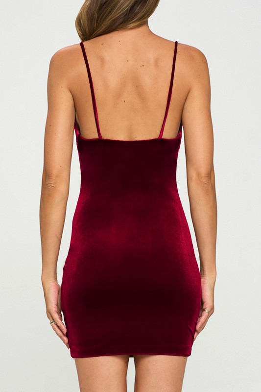 A velvet mini dress featuring a cowl neck and a bodycon silhouette.