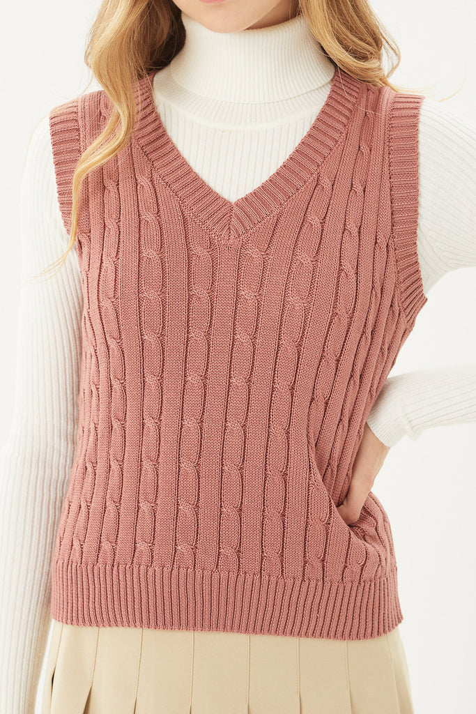 A woven sleeveless knit sweater vest featuring cable-knit stitching 