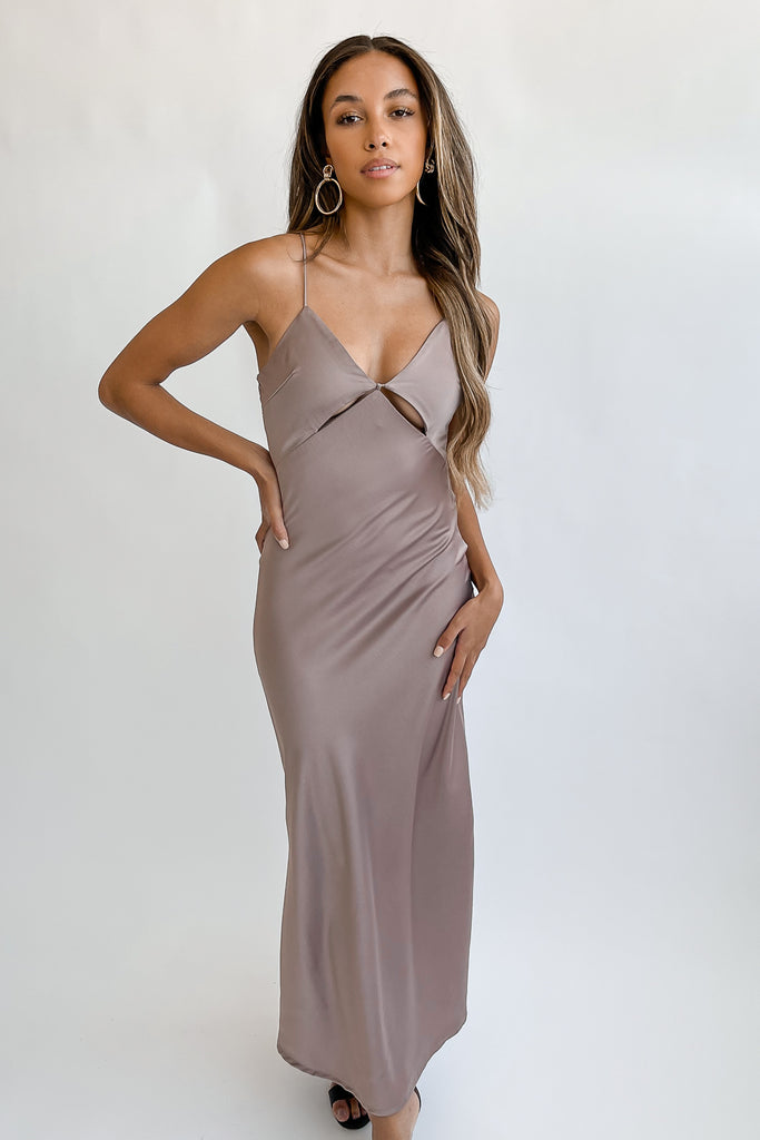 A slip maxi dress featuring cutouts in the front, crisscross adjustable tie-back, a slits and, v-neckline.