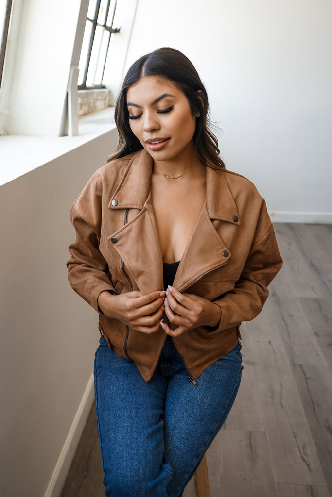A faux suede jacket featuring a zipper, a collar, zipper pockets and long sleeves.