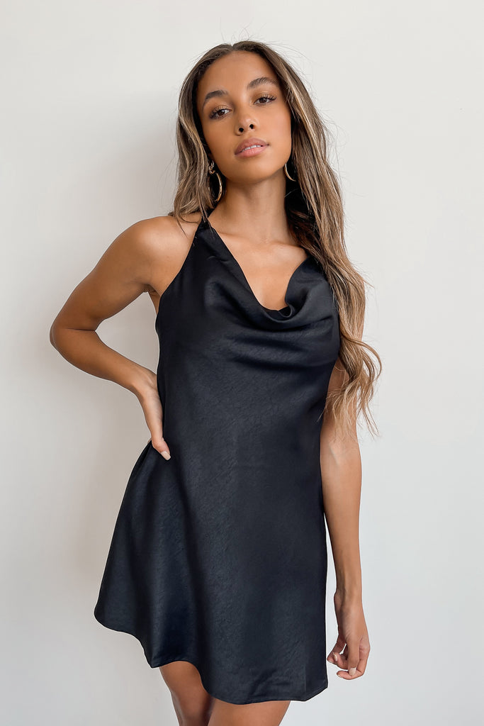 A black satin halter dress featuring a self-tie neck, plunging neckline with an open back.