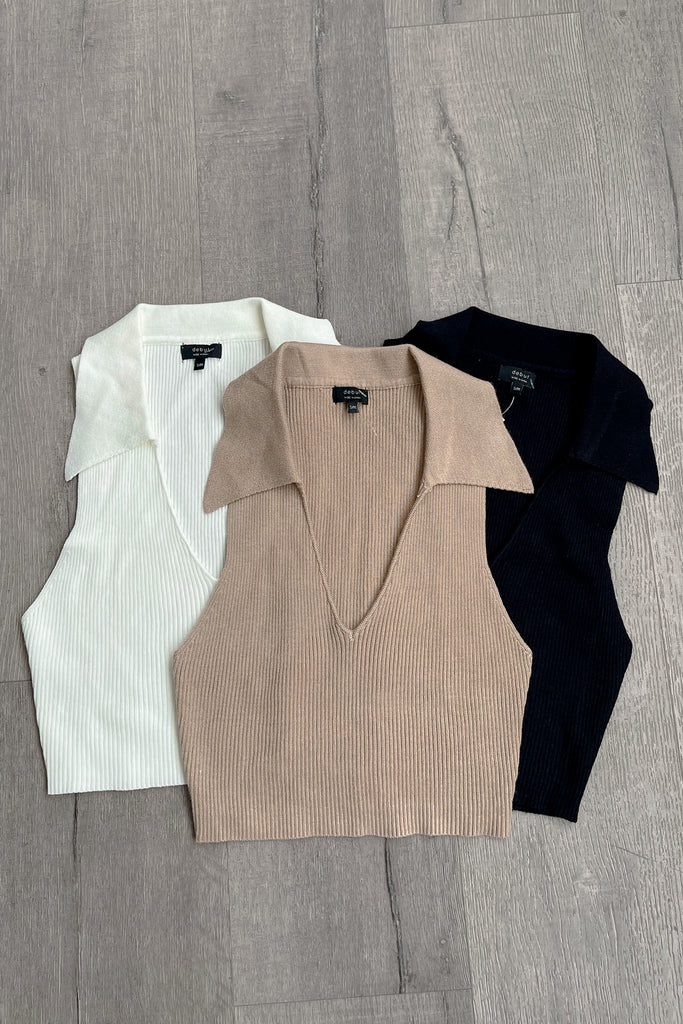 A Ribbed knit crop top featuring a collar, and a deep v-neckline.