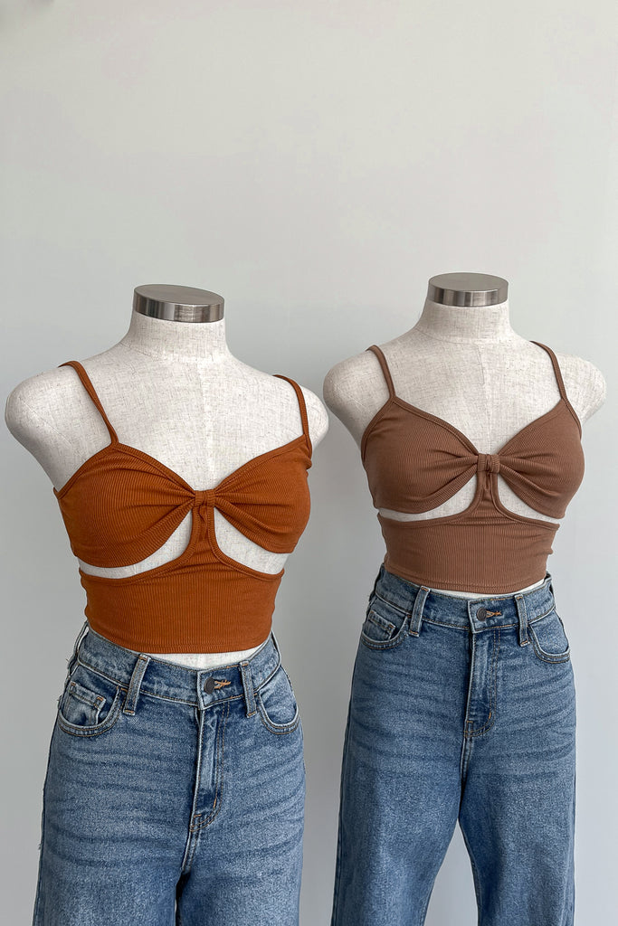 A crop top featuring a knot front look and side cut out.