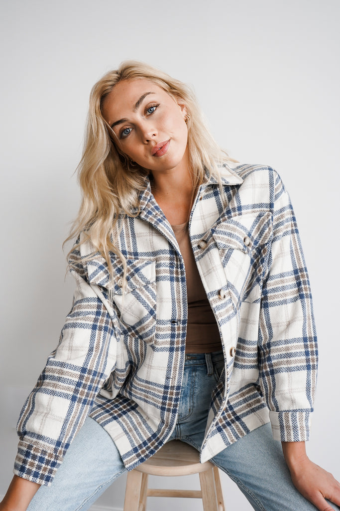 A plaid oversized button-up jacket featuring a collar, long sleeves and pockets.