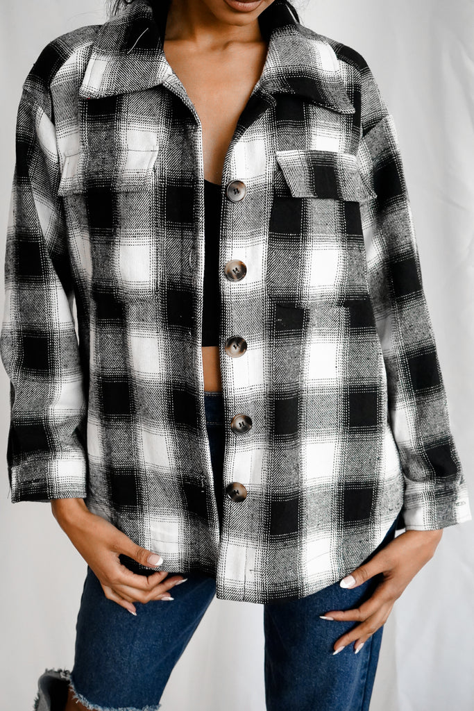 A button-up shacket featuring a collar, long sleeves and po