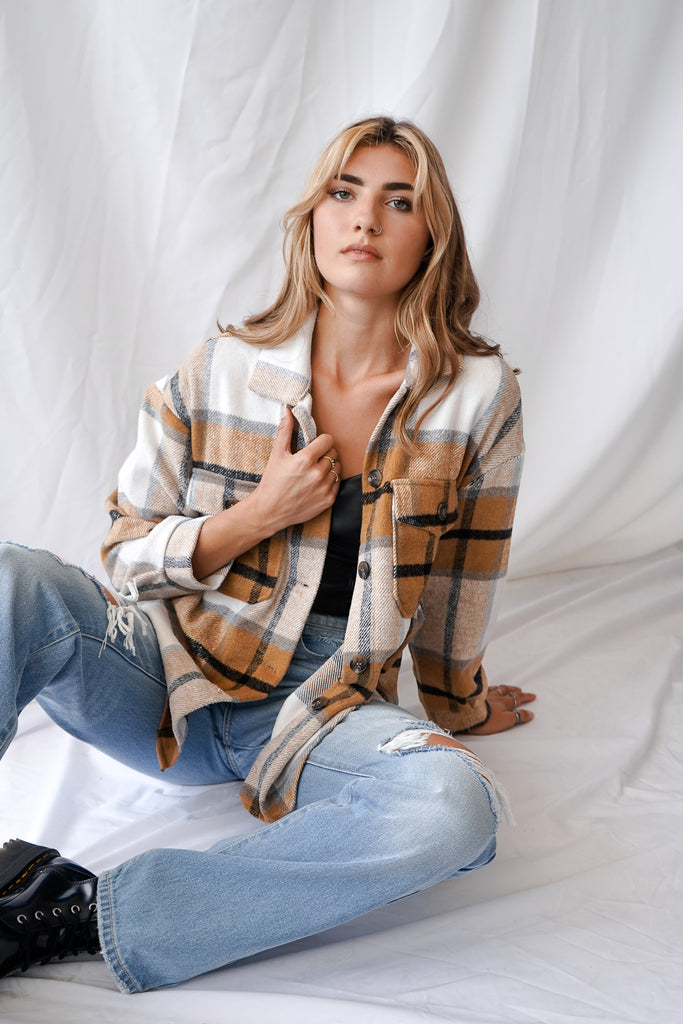 A button-up jacket featuring a collar, long sleeves and pockets.