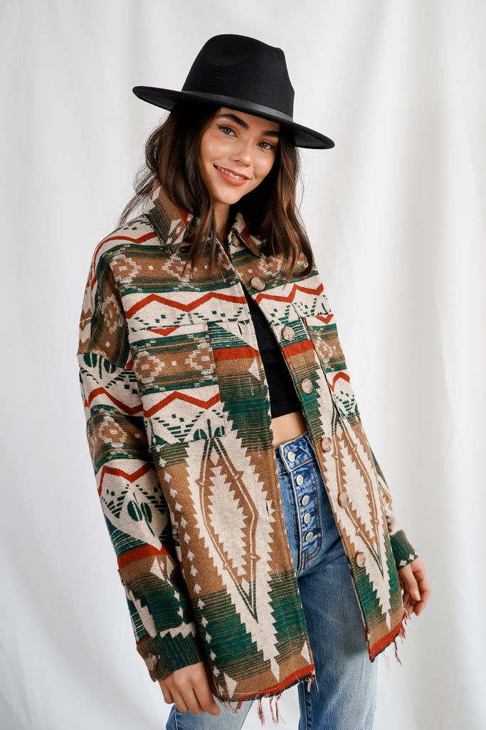 An Aztec pattern button-up shacket featuring a collar, long sleeves, pockets, and oversized fitting.