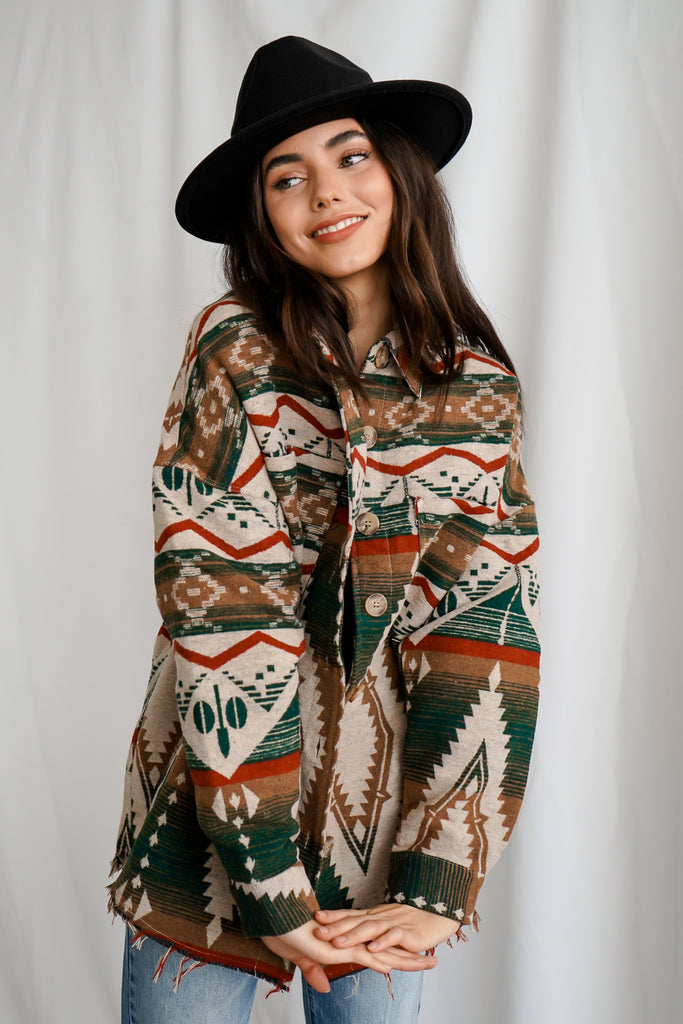 An Aztec pattern button-up shacket featuring a collar, long sleeves, pockets, and oversized fitting.