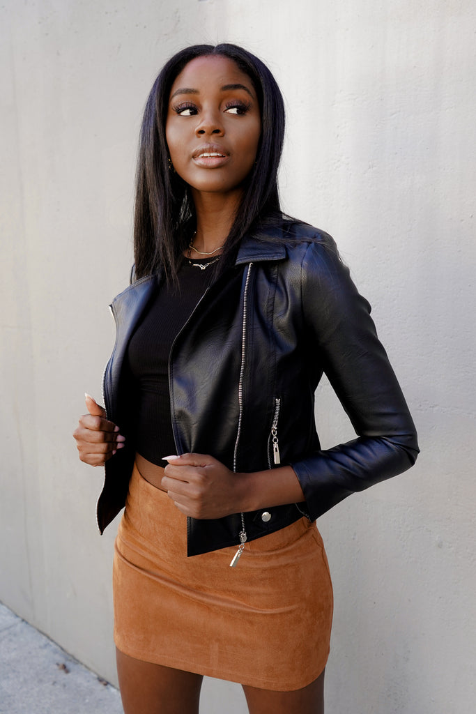 A faux leather jacket featuring a zip-up, a collar, zipper pockets and long sleeves.