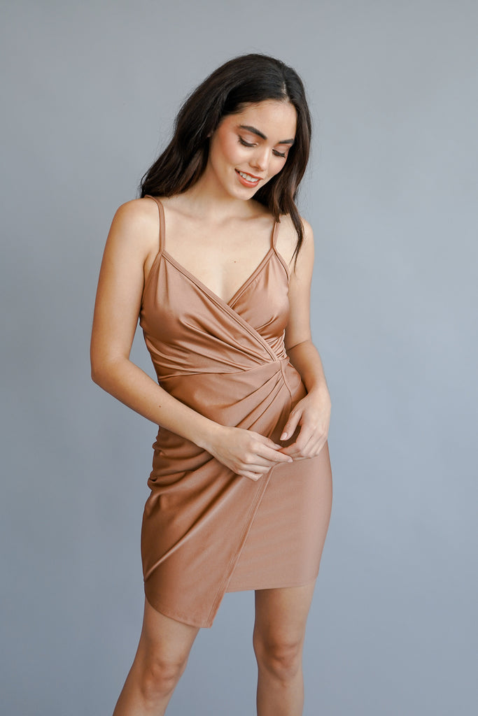 A midi dress featuring a v-neck, and cami straps. 