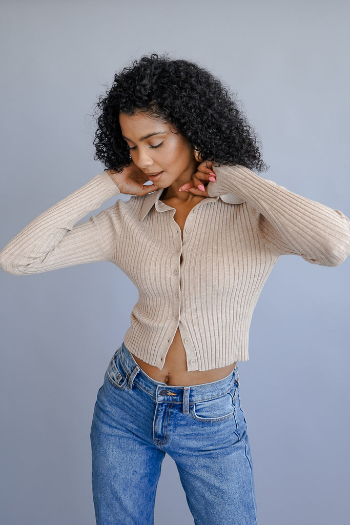 A ribbed long sleeve collard crop top featuring a button closure.