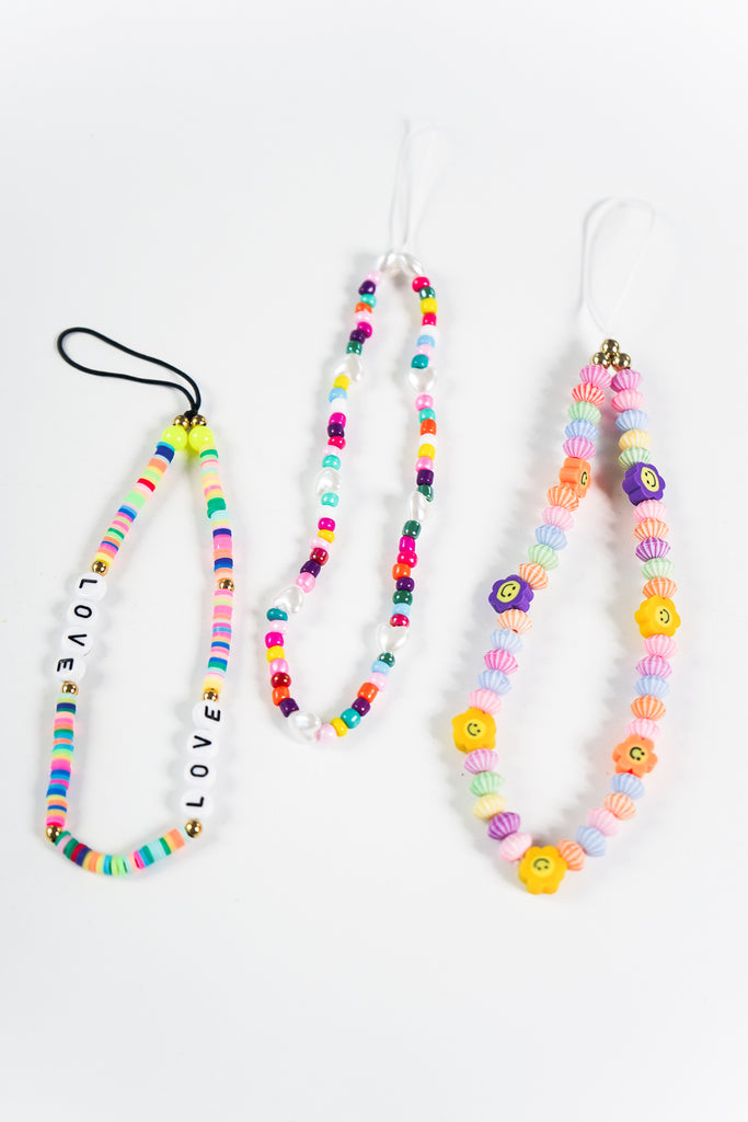 Perfect for toting your phone or instant camera, this colorful beaded wrist strap adds a nostalgic touch to modern essentials. Featuring an assortment of sweet beads topped with a loop for attaching to your tech.