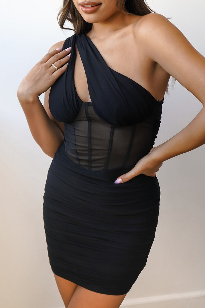 A mesh slim-fitting dress featuring an allover ruched construction, one-shoulder neckline, mini length, and a bodycon silhouette.