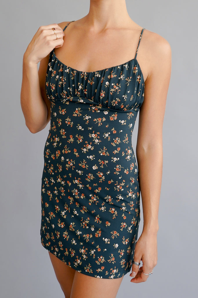 An all over floral print dress featuring a scoop neck and cami straps.