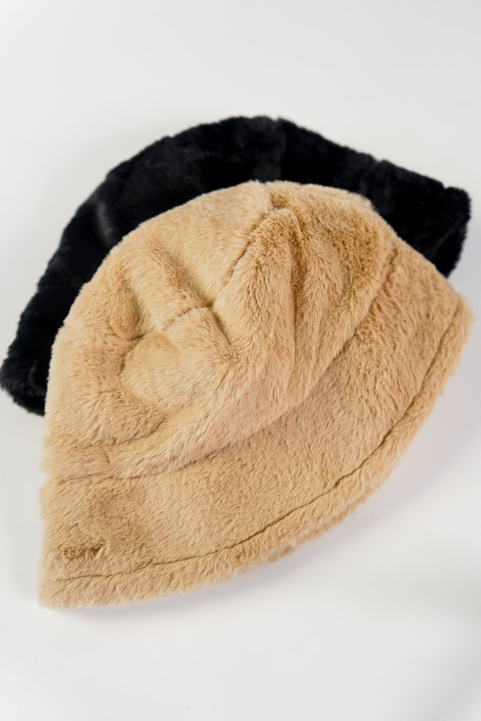 A faux fur bucket hat featuring a wide brim.