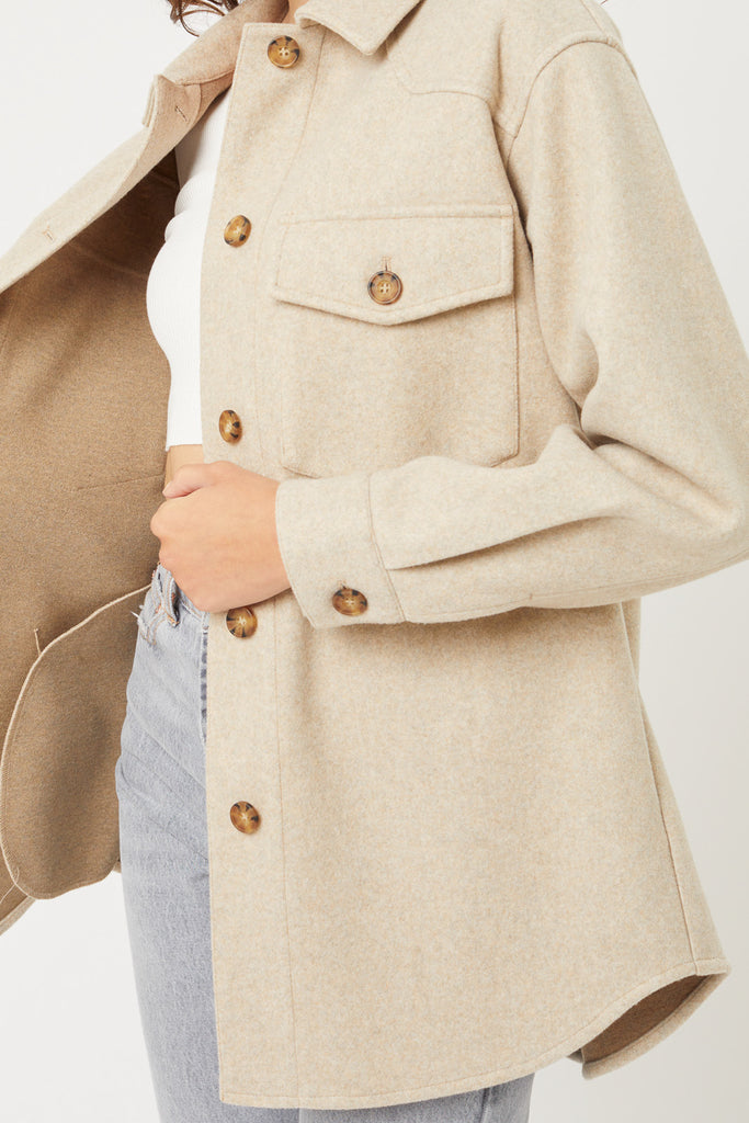 An oversized button-up jacket featuring a collar, long sleeves and pockets.