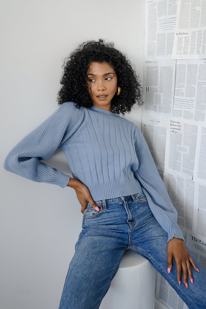 A thick knit sweater featuring long balloon sleeves and a crew neck.