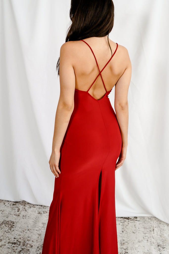 A maxi dress featuring a v-neck, slit on a side, and cami straps.