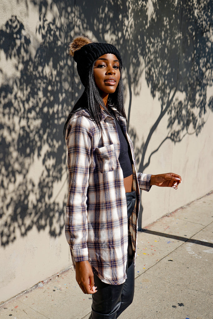 An oversized long button-up jacket featuring a collar, long sleeves and pockets.