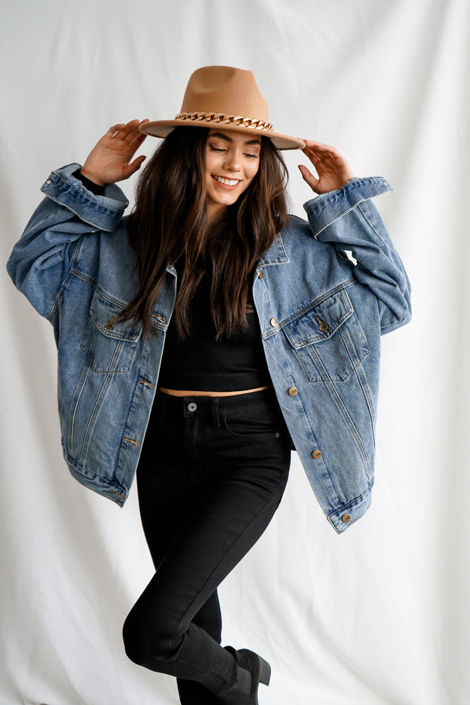 A denim jacket featuring a relaxed oversized fit, button front closures, a basic collar, chest pockets, dropped long sleeves, and slant pockets.