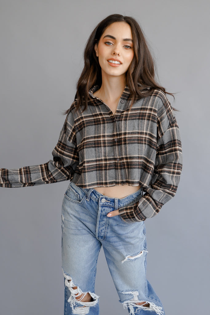 A plaid crop jacket featuring long sleeves, button-up in front and back, and a collar.