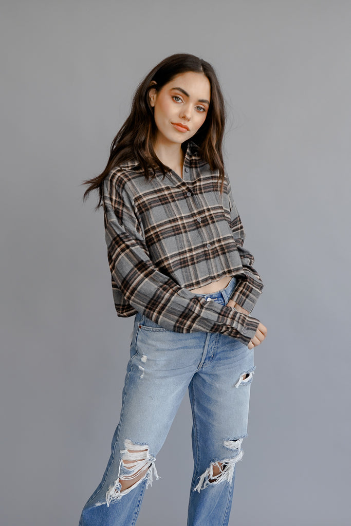 A plaid crop jacket featuring long sleeves, button-up in front and back, and a collar.
