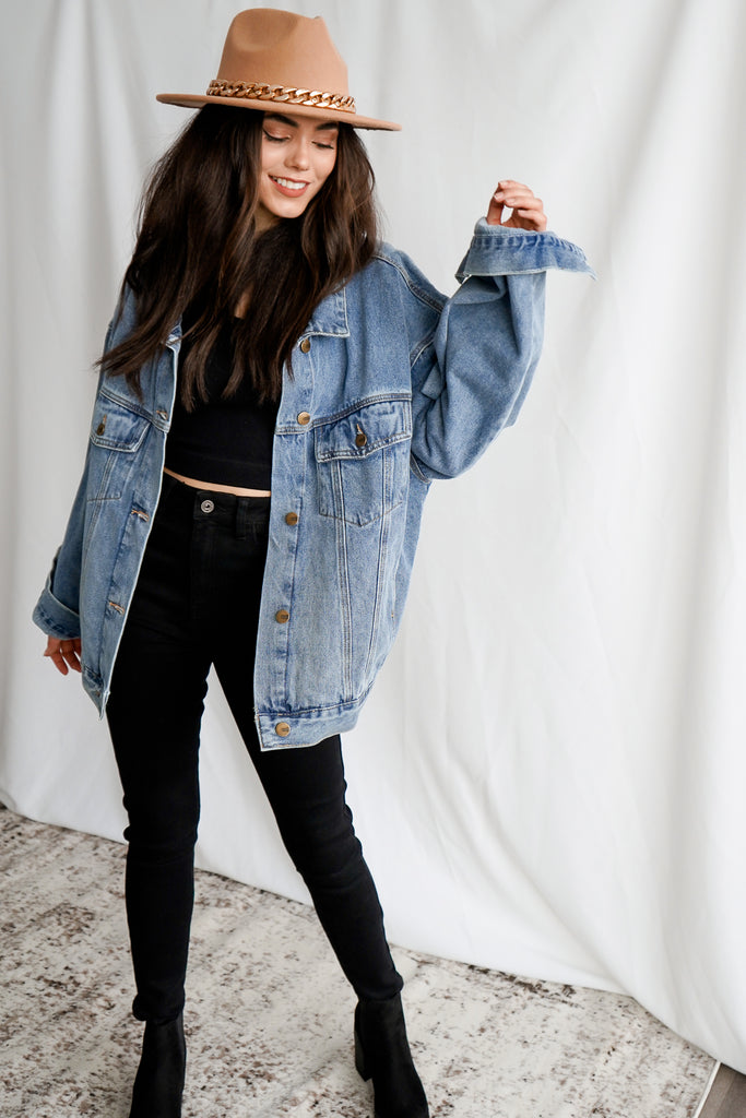 A denim jacket featuring a relaxed oversized fit, button front closures, a basic collar, chest pockets, dropped long sleeves, and slant pockets.