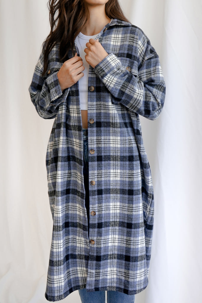 A blue oversized long button-up jacket featuring a collar and pockets. 