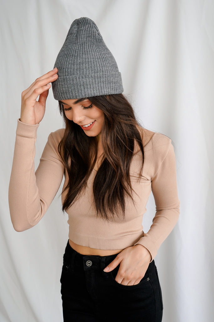 A ribbed knit long sleeve shoulder top featuring a v-neck.