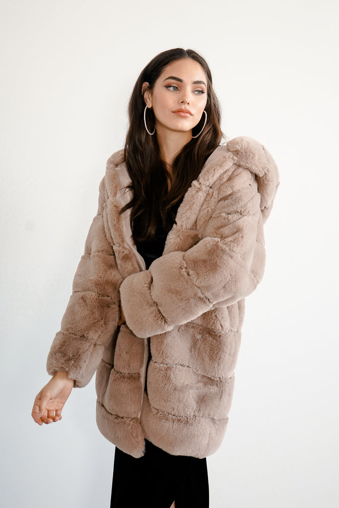 A faux fur shearling coat featuring a hood, open front, and long sleeves.