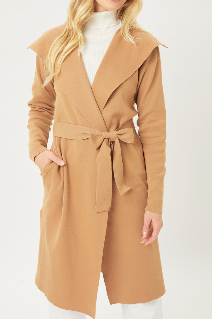 A brushed woven duster coat featuring wide lapels, long sleeves, an open-front with self-tie sash belt, and a longline hem.