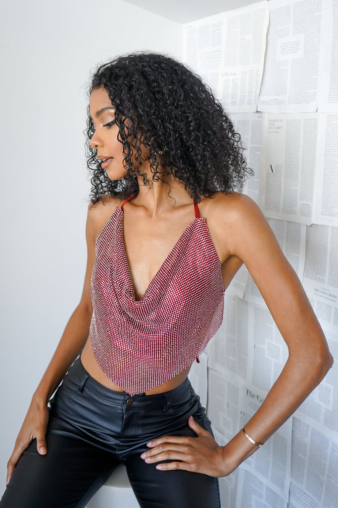 A rhinestone bandana halter top featuring a cowl neck, and self-tie open back.