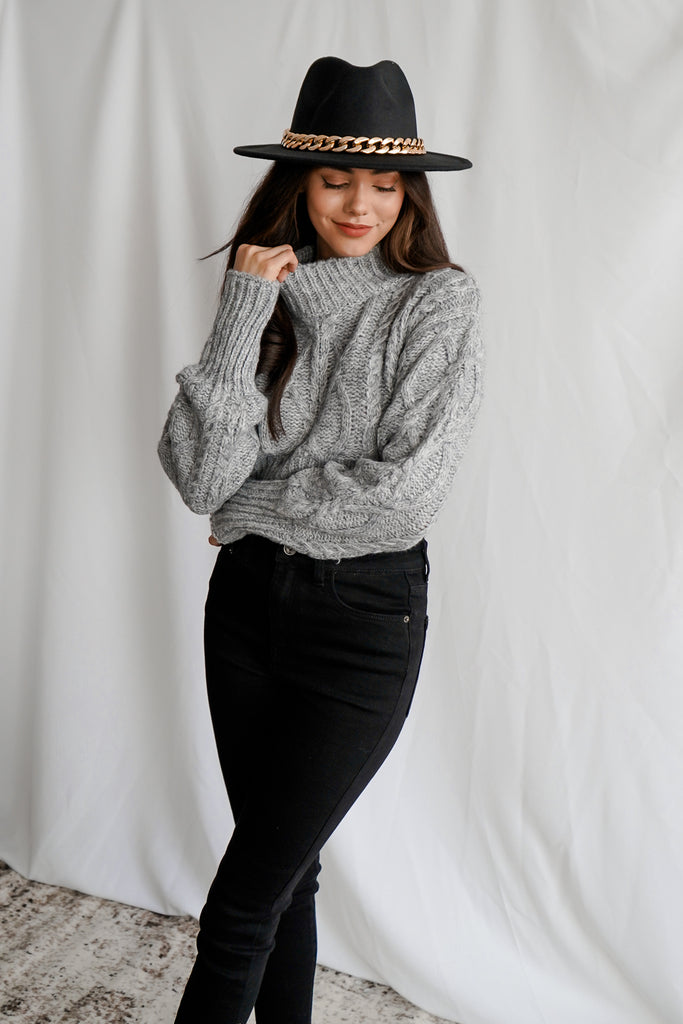 A cropped turtleneck long sleeve thick knit sweater.