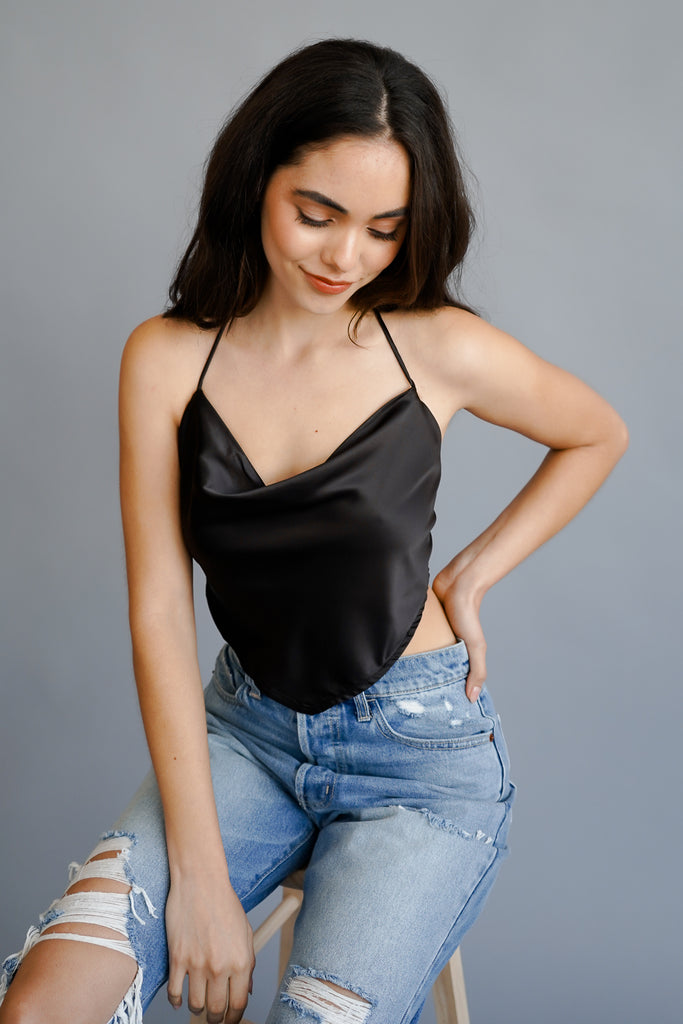 A crop top featuring halter straps, and an adjustable self-tie back.