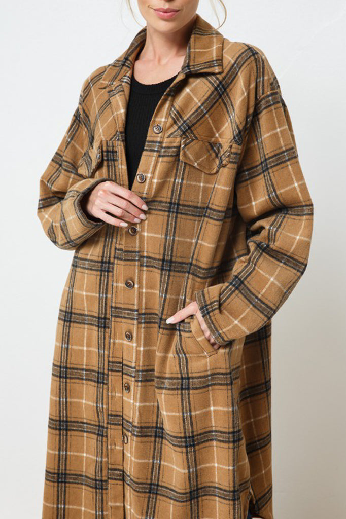 An oversized long button-up jacket featuring a collar, long sleeves and pockets.