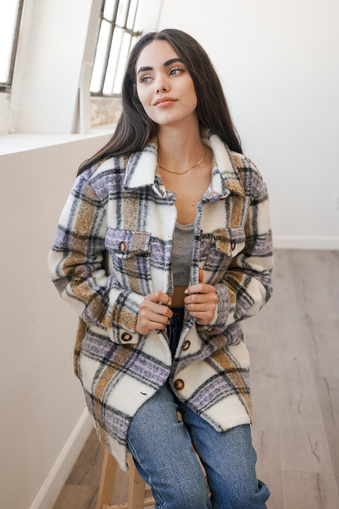 An oversized button-up jacket featuring a collar, long sleeves and pockets.